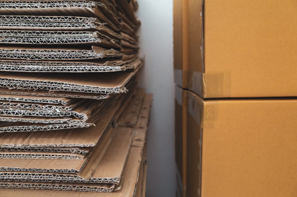 Corrugated cardboard boxes stacked close to new brown carton boxes stacked KSS Enterprises